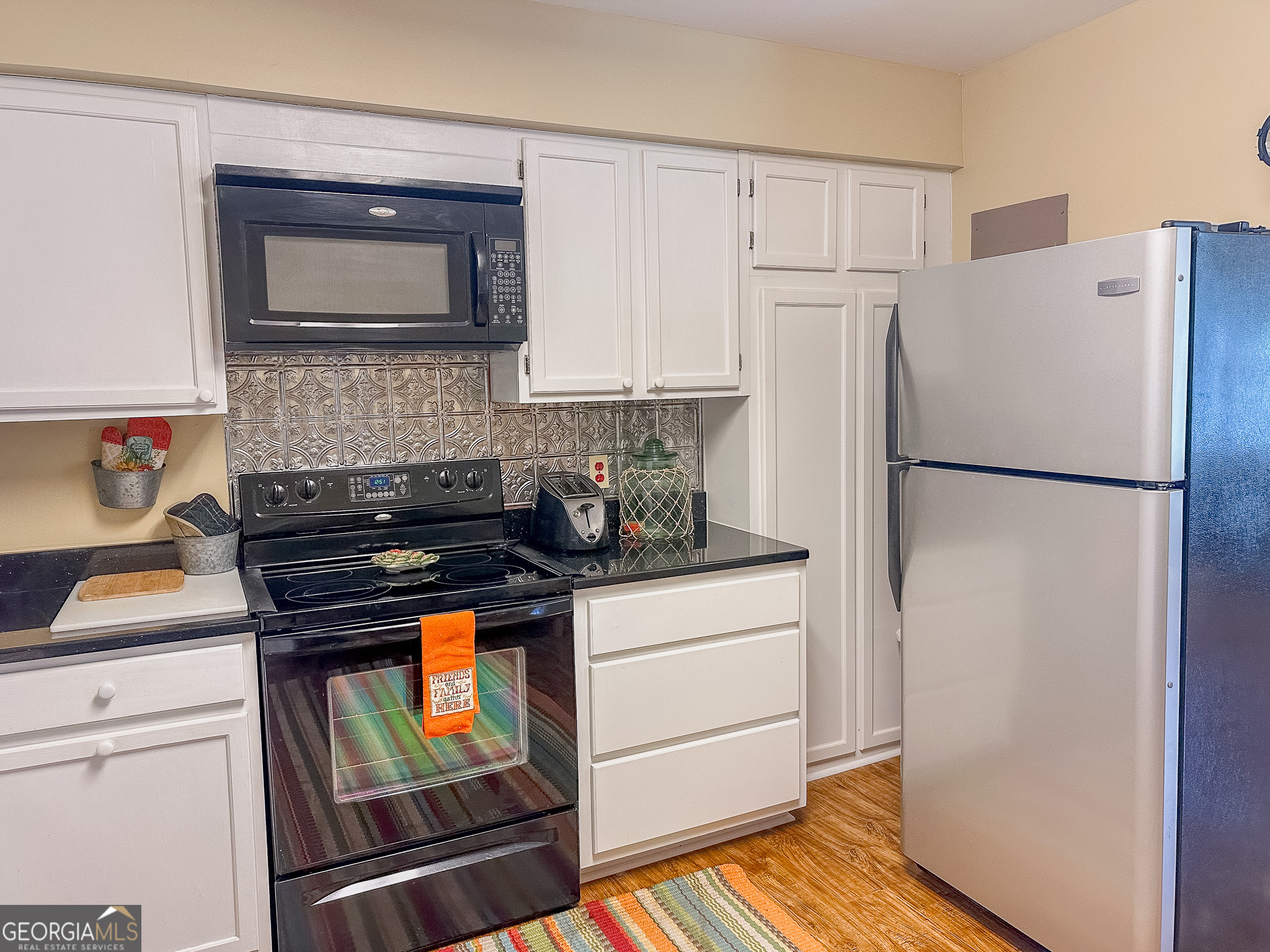 110 Tom Holman Road Cobb, GA 31735 - Photo 7 of 18 a kitchen with a refrigerator and a stove top oven