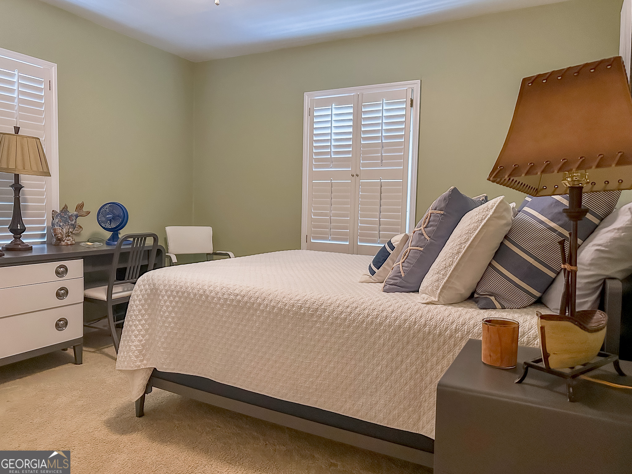 110 Tom Holman Road Cobb, GA 31735 - Photo 9 of 18 a bedroom with a bed and lamp