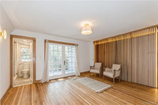 a view of a bedroom with furniture and wooden floor