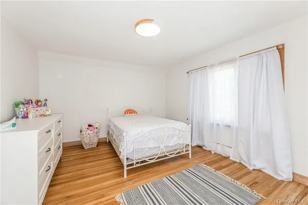 a room with a bed and wooden floor