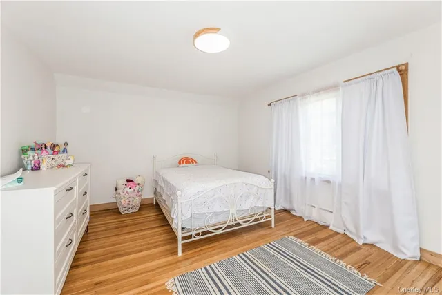 a room with a bed and wooden floor