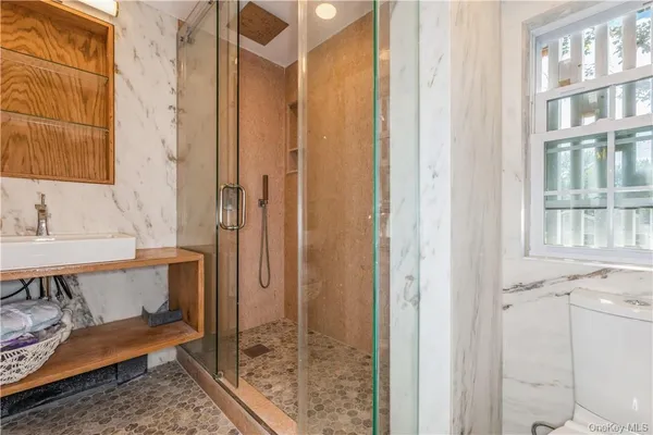 a bathroom with a tub and shower