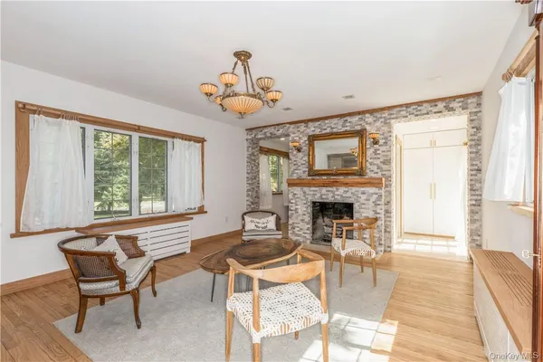 a living room with furniture a fireplace and a large window