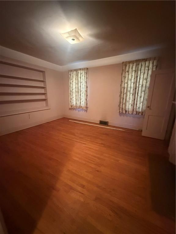 2808 Summerville Road Phenix City, AL 36867 - Photo 7 of 15 Unfurnished bedroom featuring wood finished floors and baseboards