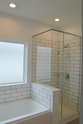 a bathroom with a shower and a bathtub