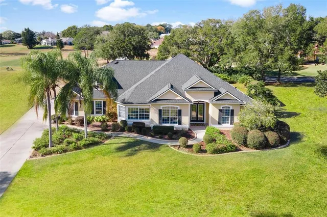 an aerial view of a house with swimming pool and garden