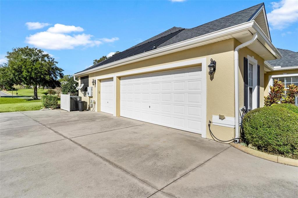 5903 Spinnaker Loop Lady Lake, FL 32159 - Photo 11 of 73 a view of a white house with a yard and garage