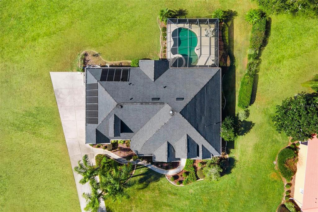 5903 Spinnaker Loop Lady Lake, FL 32159 - Photo 2 of 73 an aerial view of a house with swimming pool and garden