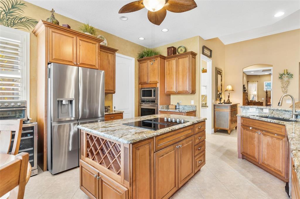 5903 Spinnaker Loop Lady Lake, FL 32159 - Photo 25 of 73 a kitchen with stainless steel appliances granite countertop a stove and a refrigerator