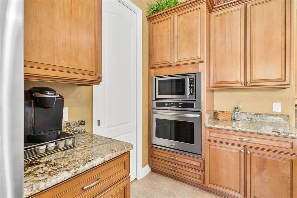 5903 Spinnaker Loop Lady Lake, FL 32159 - Photo 26 of 73 a kitchen with granite countertop cabinets stainless steel appliances and a counter space