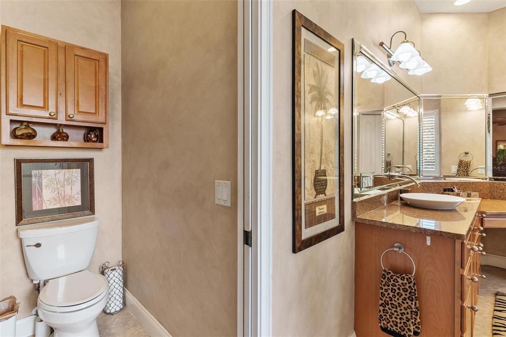 5903 Spinnaker Loop Lady Lake, FL 32159 - Photo 32 of 73 a bathroom with a sink a toilet and a mirror