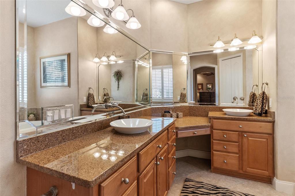 5903 Spinnaker Loop Lady Lake, FL 32159 - Photo 35 of 73 a bathroom with a granite countertop sink a large mirror and a toilet