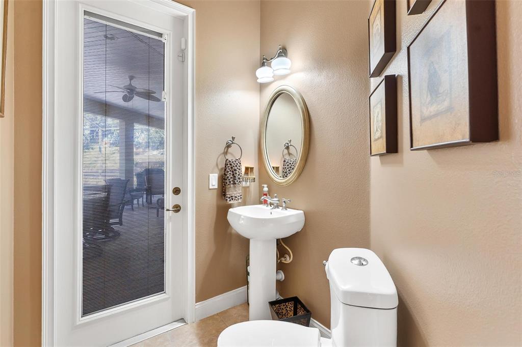 5903 Spinnaker Loop Lady Lake, FL 32159 - Photo 39 of 73 a bathroom with a toilet sink and mirror