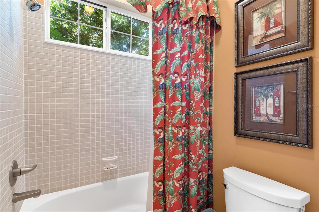 5903 Spinnaker Loop Lady Lake, FL 32159 - Photo 43 of 73 a bathroom with a toilet and a shower curtain