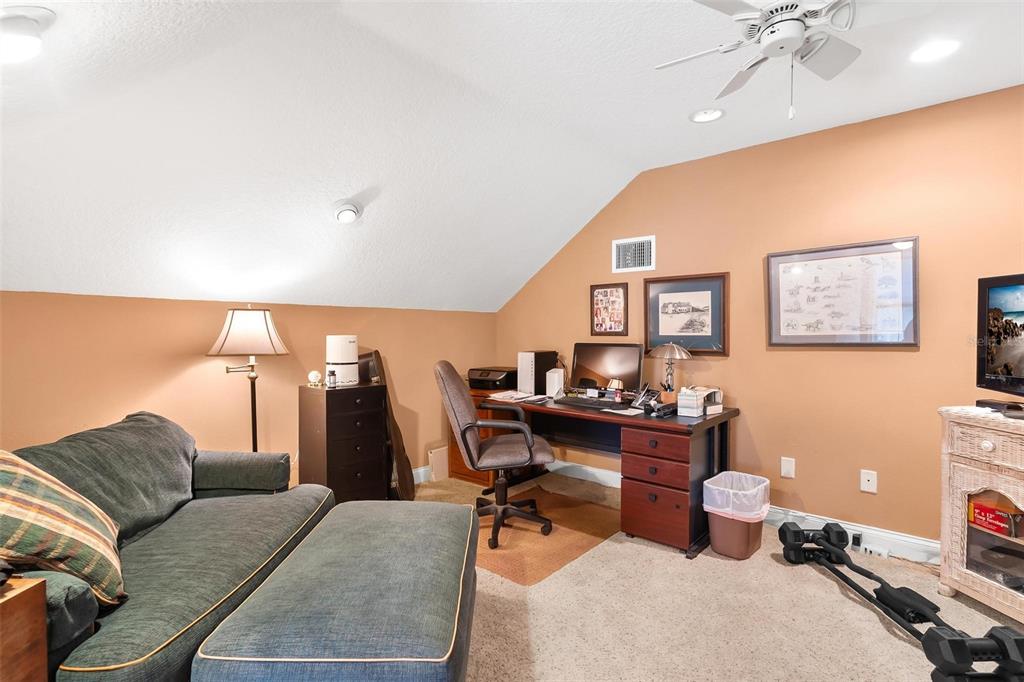 5903 Spinnaker Loop Lady Lake, FL 32159 - Photo 50 of 73 a living room with furniture and a chandelier