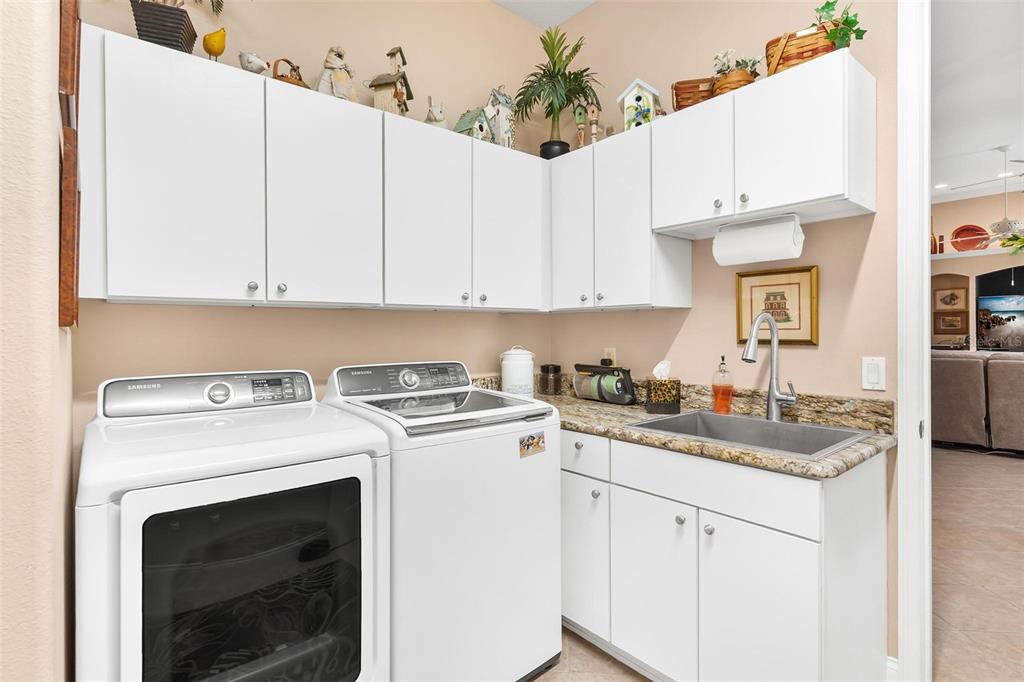5903 Spinnaker Loop Lady Lake, FL 32159 - Photo 57 of 73 a kitchen with a sink stove and cabinets