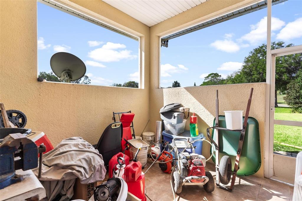 5903 Spinnaker Loop Lady Lake, FL 32159 - Photo 60 of 73 a view of a workspace with furniture and a floor to ceiling window