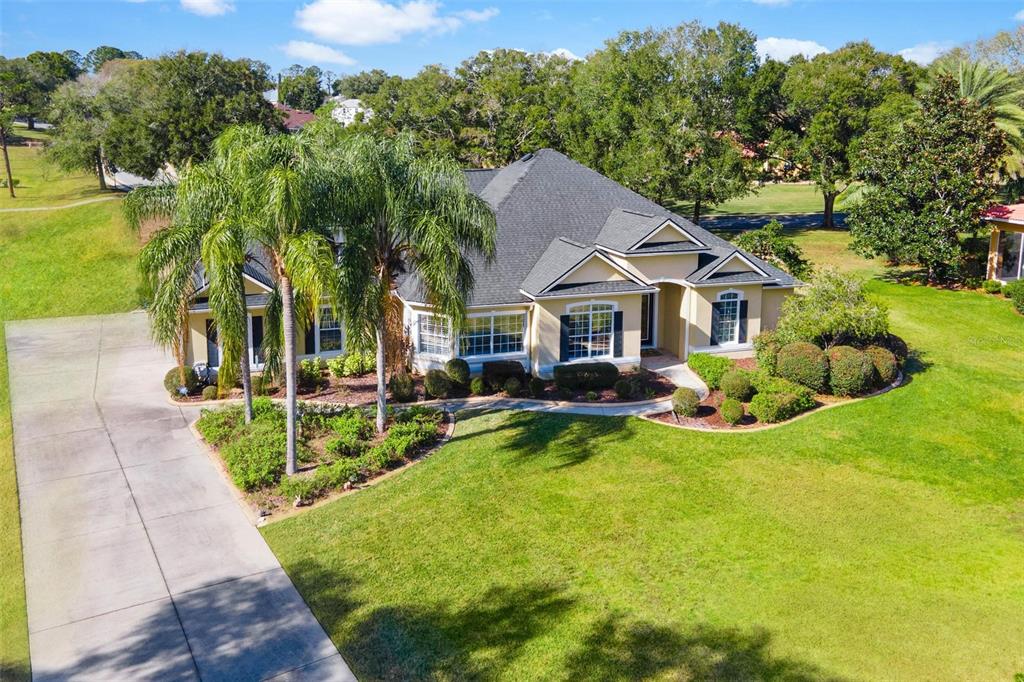 5903 Spinnaker Loop Lady Lake, FL 32159 - Photo 62 of 73 a view of house with garden and tall trees