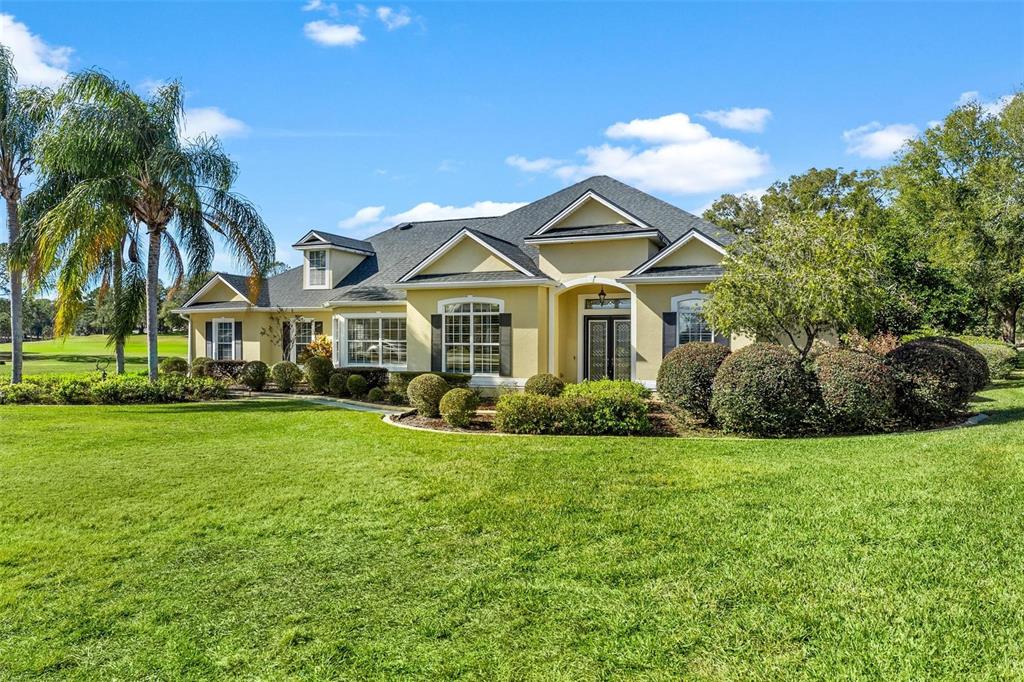 5903 Spinnaker Loop Lady Lake, FL 32159 - Photo 64 of 73 a front view of a house with a garden