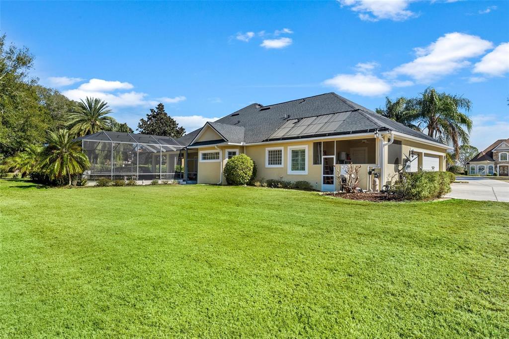 5903 Spinnaker Loop Lady Lake, FL 32159 - Photo 69 of 73 a front view of a house with a yard table and chairs
