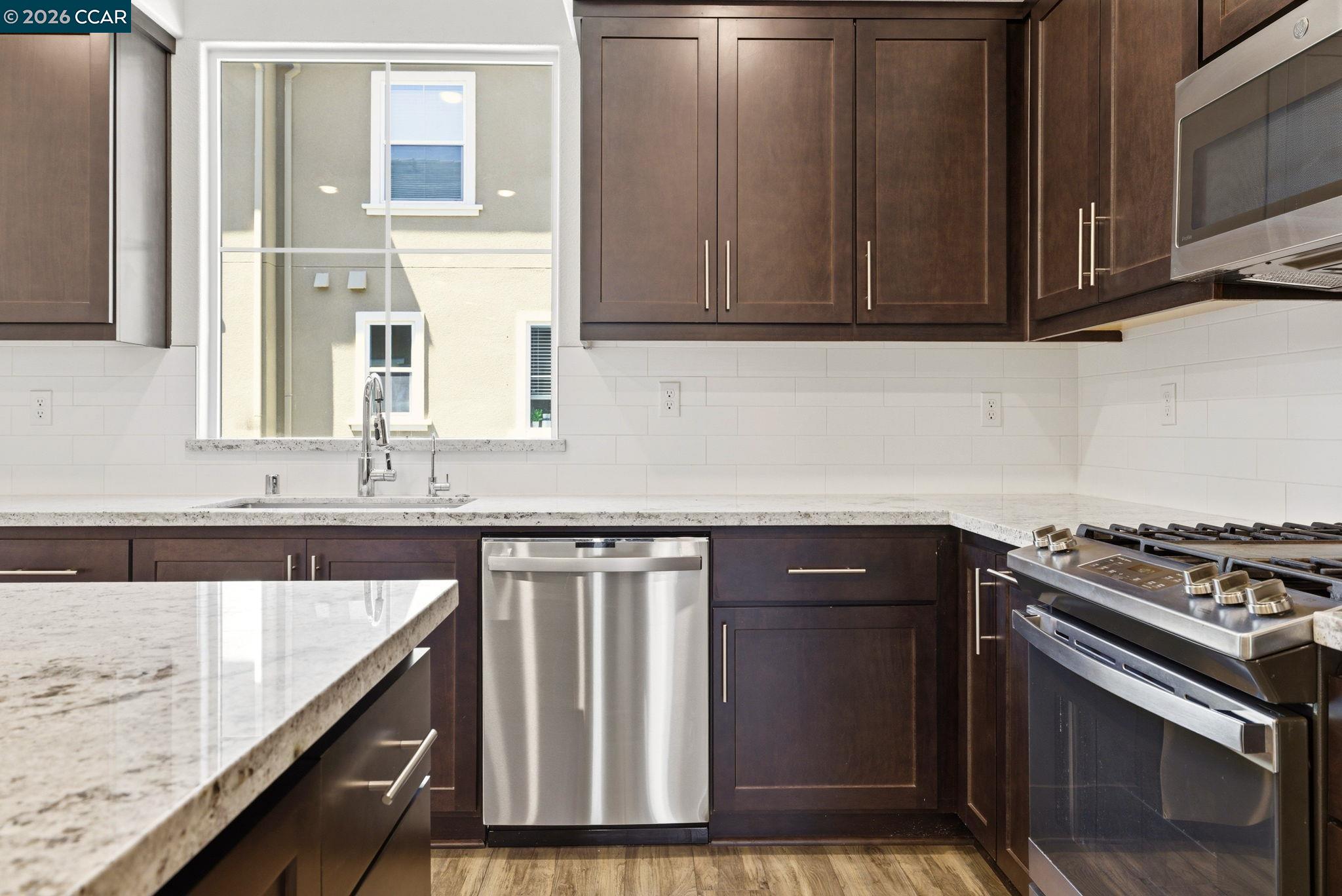 205 Plum Tree Street Livermore, CA 94551 - Photo 19 of 47 a kitchen with granite countertop a sink stove and cabinets