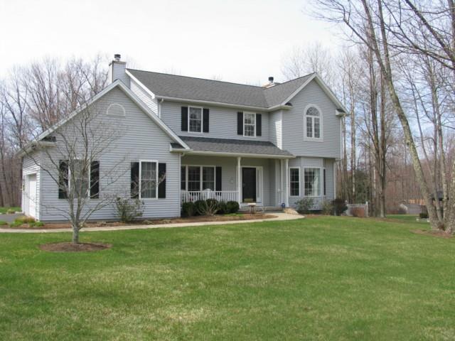 11 Deer Park Road Danbury, CT 06811 - Photo 1 of 1 a front view of a house with a garden and trees