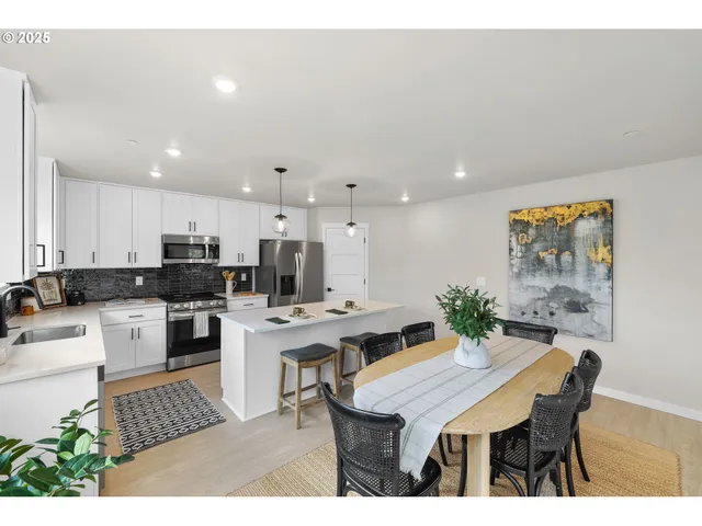 a kitchen with a table and chairs in it