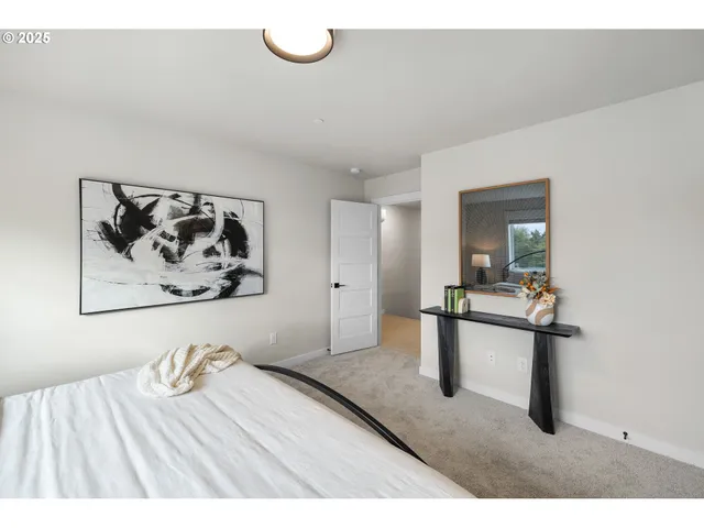 a view of a bedroom with furniture and window