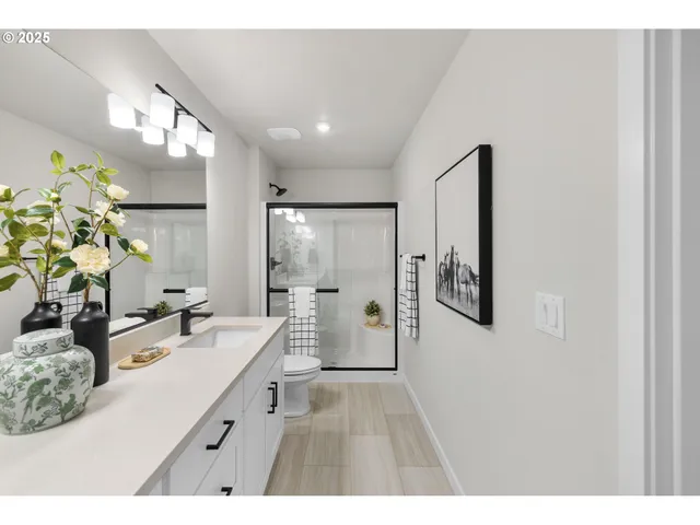 a bathroom with a double vanity sink mirror and shower