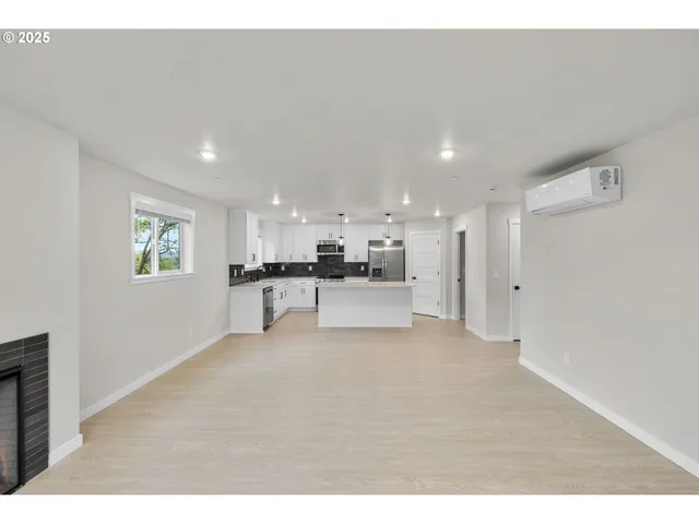 a view of kitchen with refrigerator and window