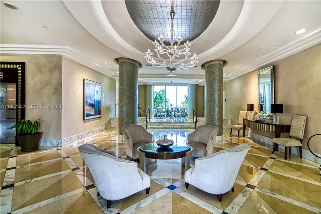 a living room with furniture a chandelier and a large mirror