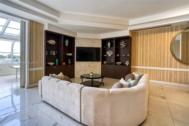 a living room with furniture and large windows