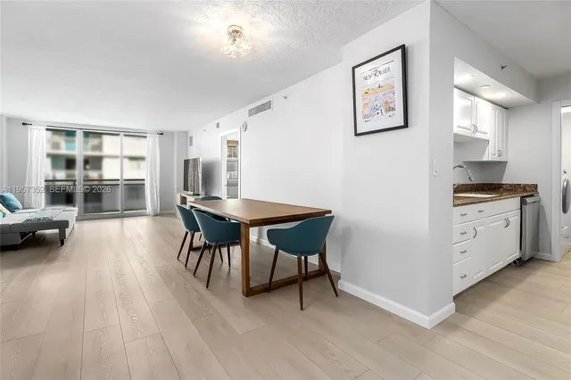 a kitchen with furniture and wooden floor