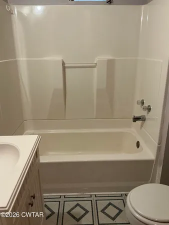 a bathroom with a sink a toilet and bathtub