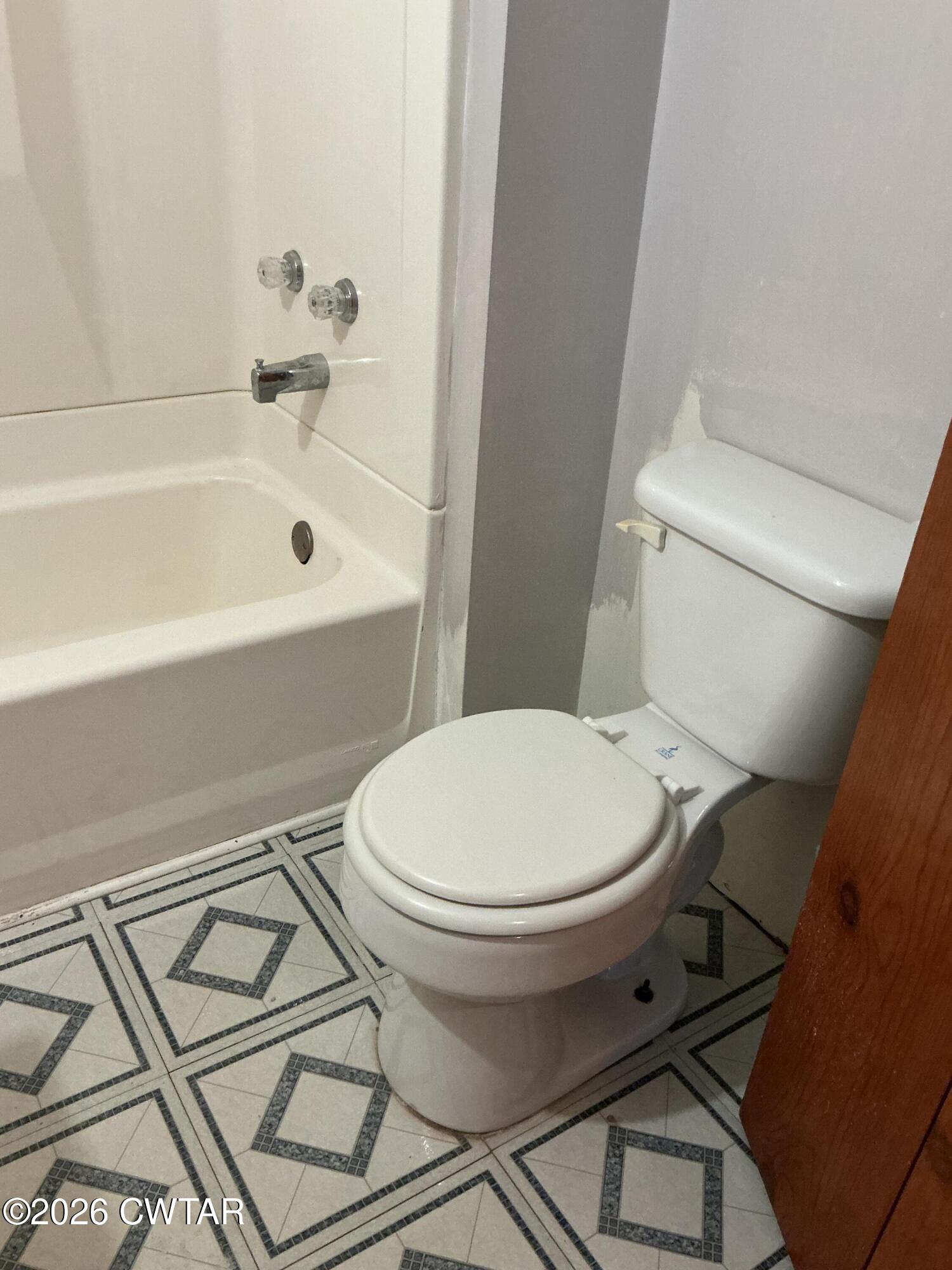 84 Carter Street Alamo, TN 38001 - Photo 13 of 25 a white toilet sitting next to a bath tub