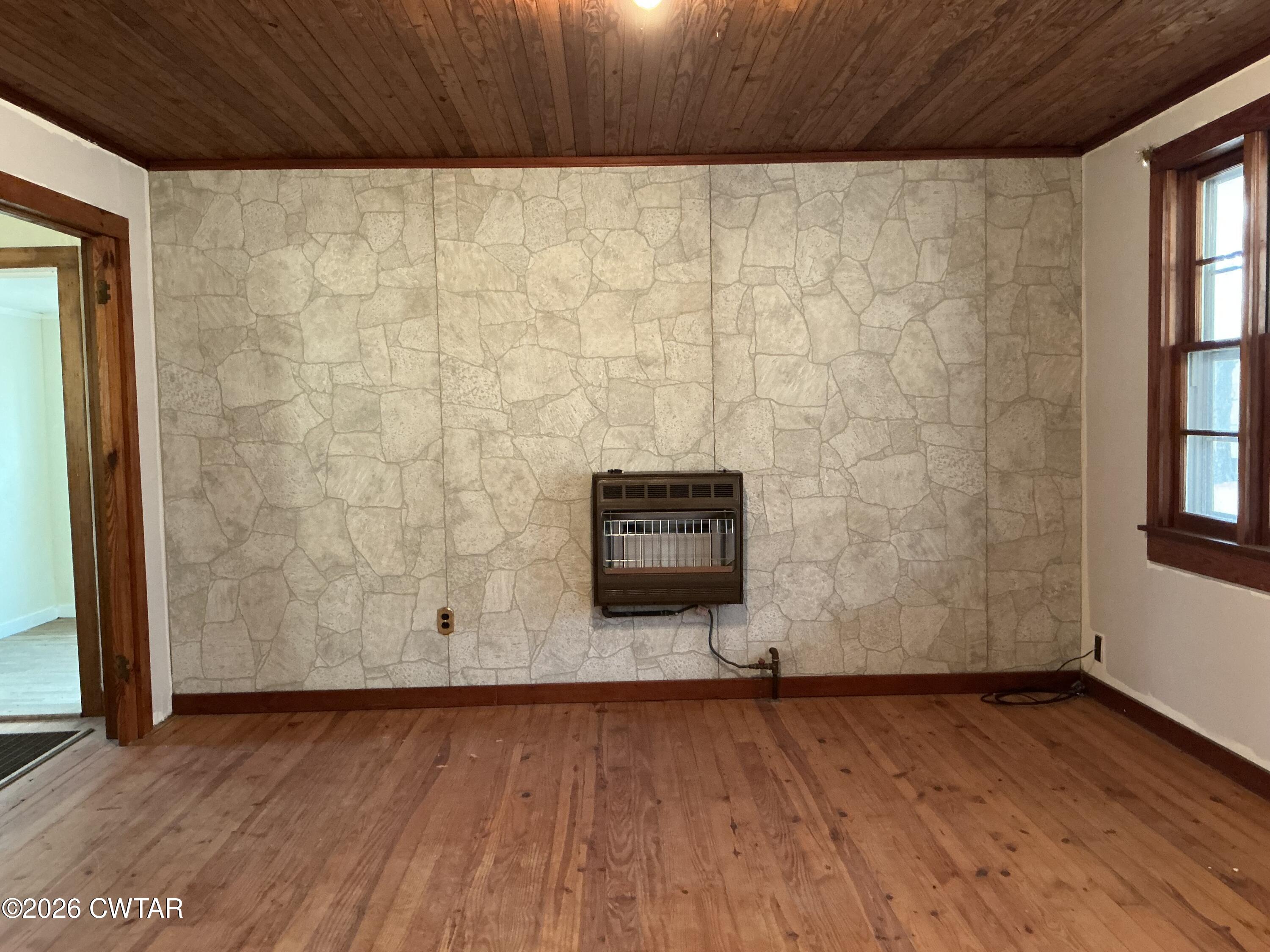 84 Carter Street Alamo, TN 38001 - Photo 20 of 25 a view of an empty room with wooden floor and a window