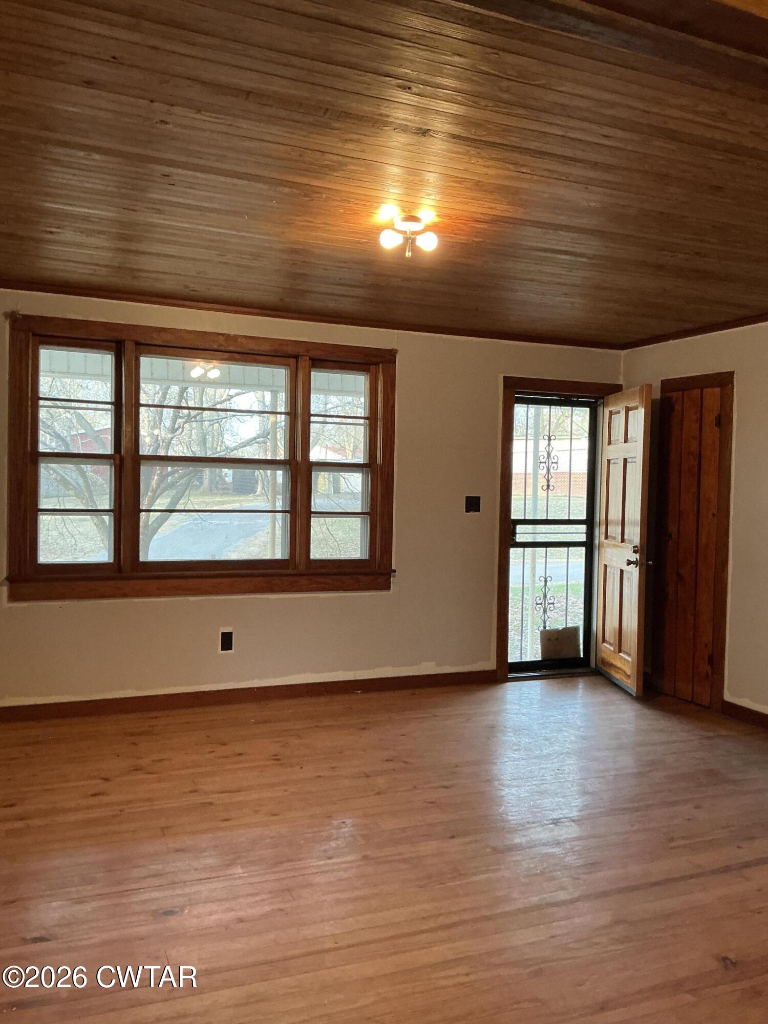 84 Carter Street Alamo, TN 38001 - Photo 22 of 25 a view of an empty room with wooden floor and a window