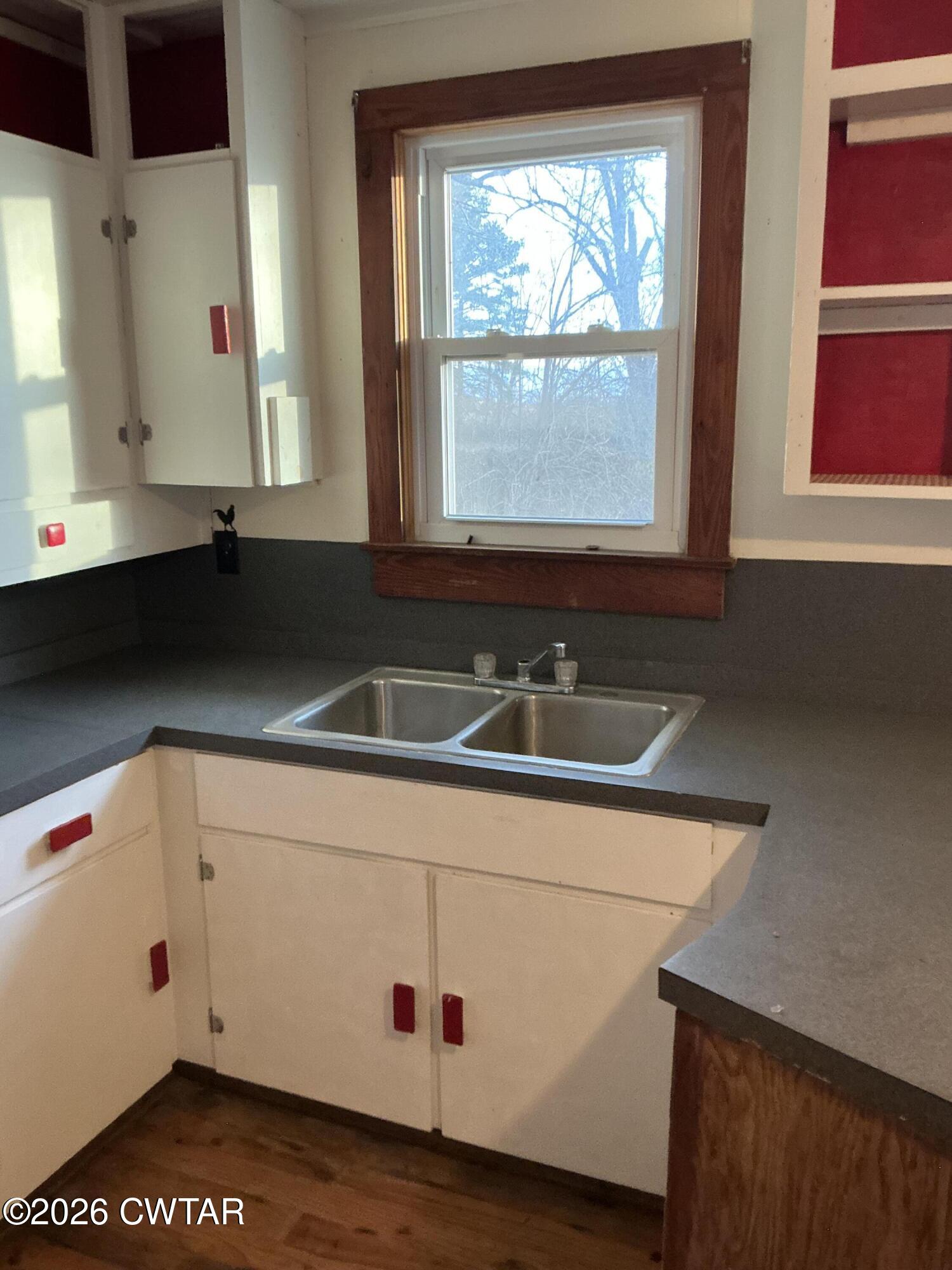 84 Carter Street Alamo, TN 38001 - Photo 6 of 25 a bathroom with a sink and a white cabinets