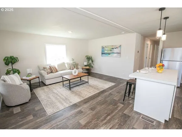 a kitchen that has a sink a stove a dining table and chairs