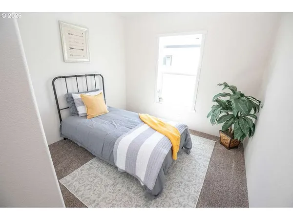 a bedroom with a bed and a potted plant