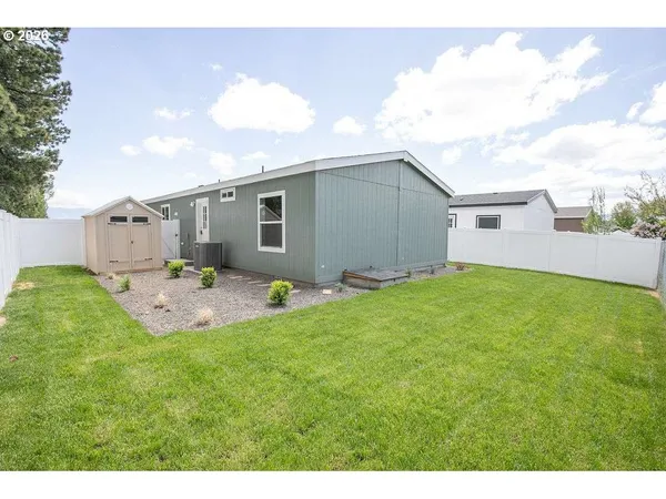 a backyard of a house with table and chairs