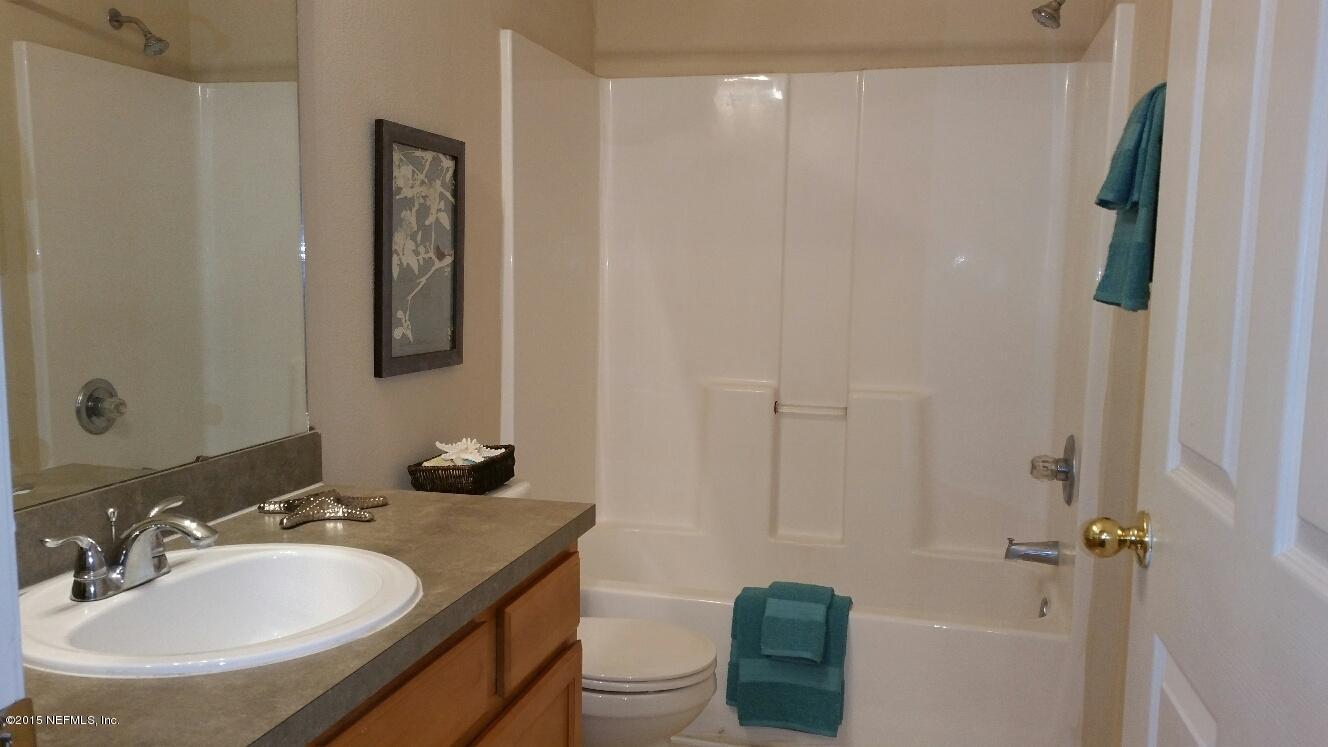 7920 Merrill Road, Unit 1804 Jacksonville, FL 32277 - Photo 12 of 35 a bathroom with a sink and mirror with toilet