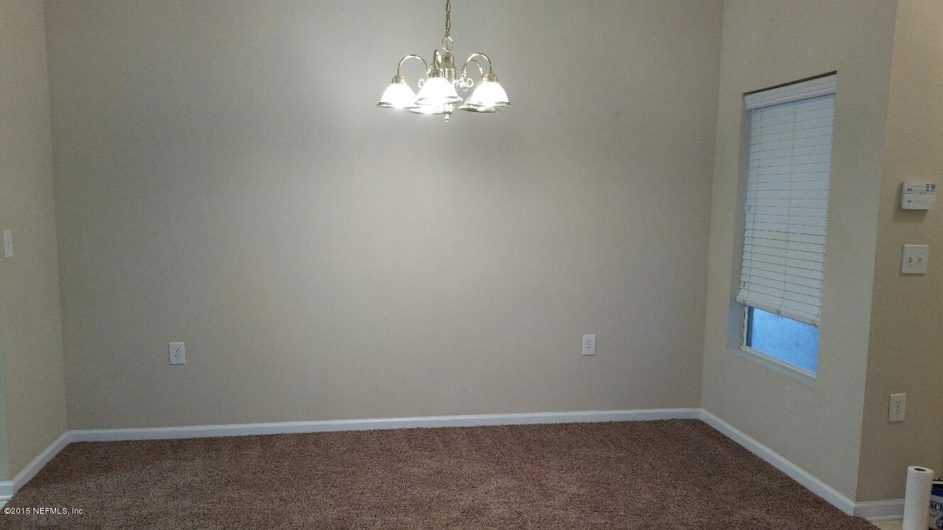 7920 Merrill Road, Unit 1804 Jacksonville, FL 32277 - Photo 4 of 35 a view of a chandelier fan and hardwood floor