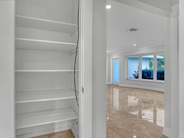 a view of a hallway with wooden floor and front door