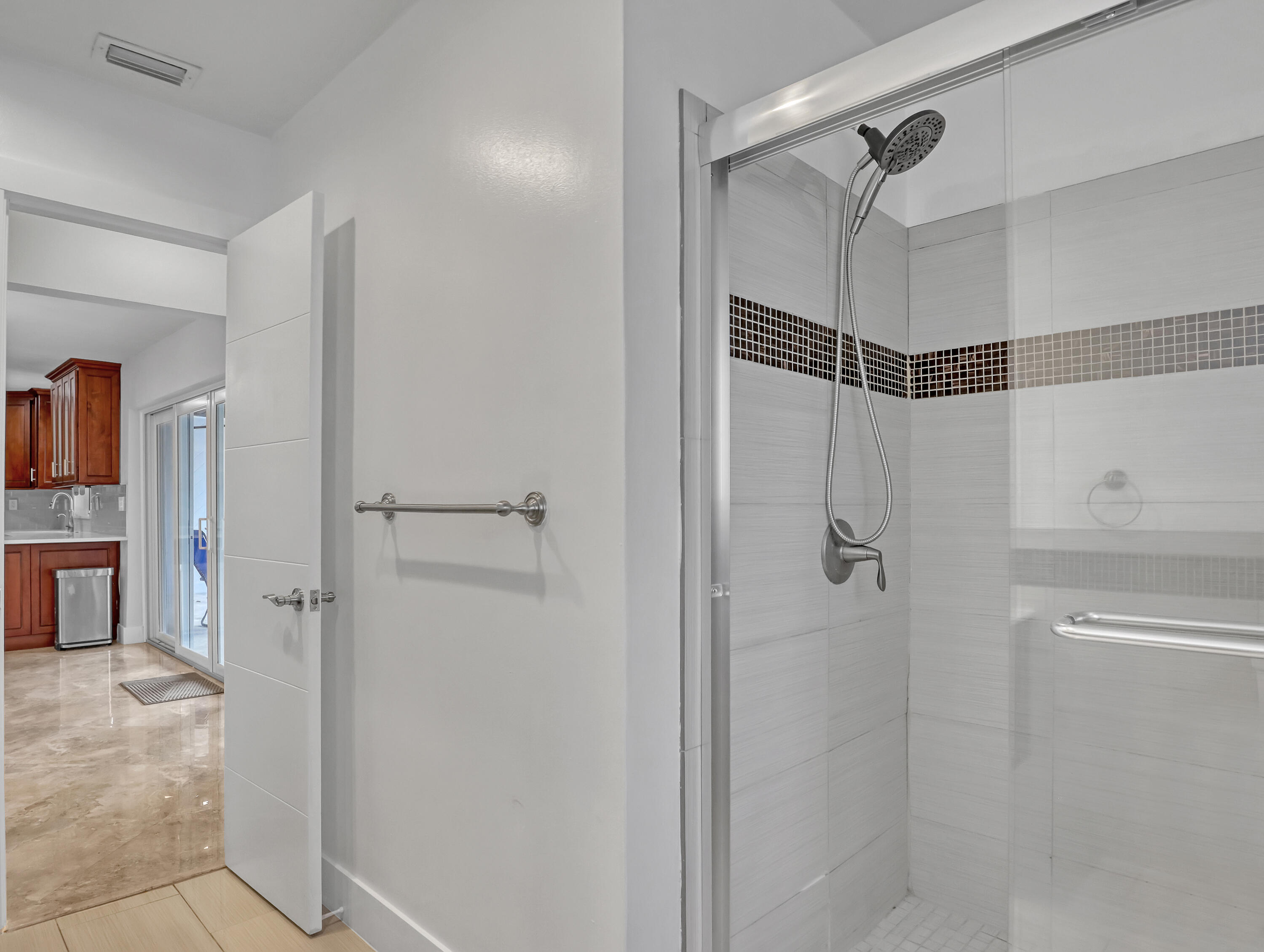 1298 Northwest 4th Street Boca Raton, FL 33486 - Photo 19 of 36 a bathroom with a shower and a glass door