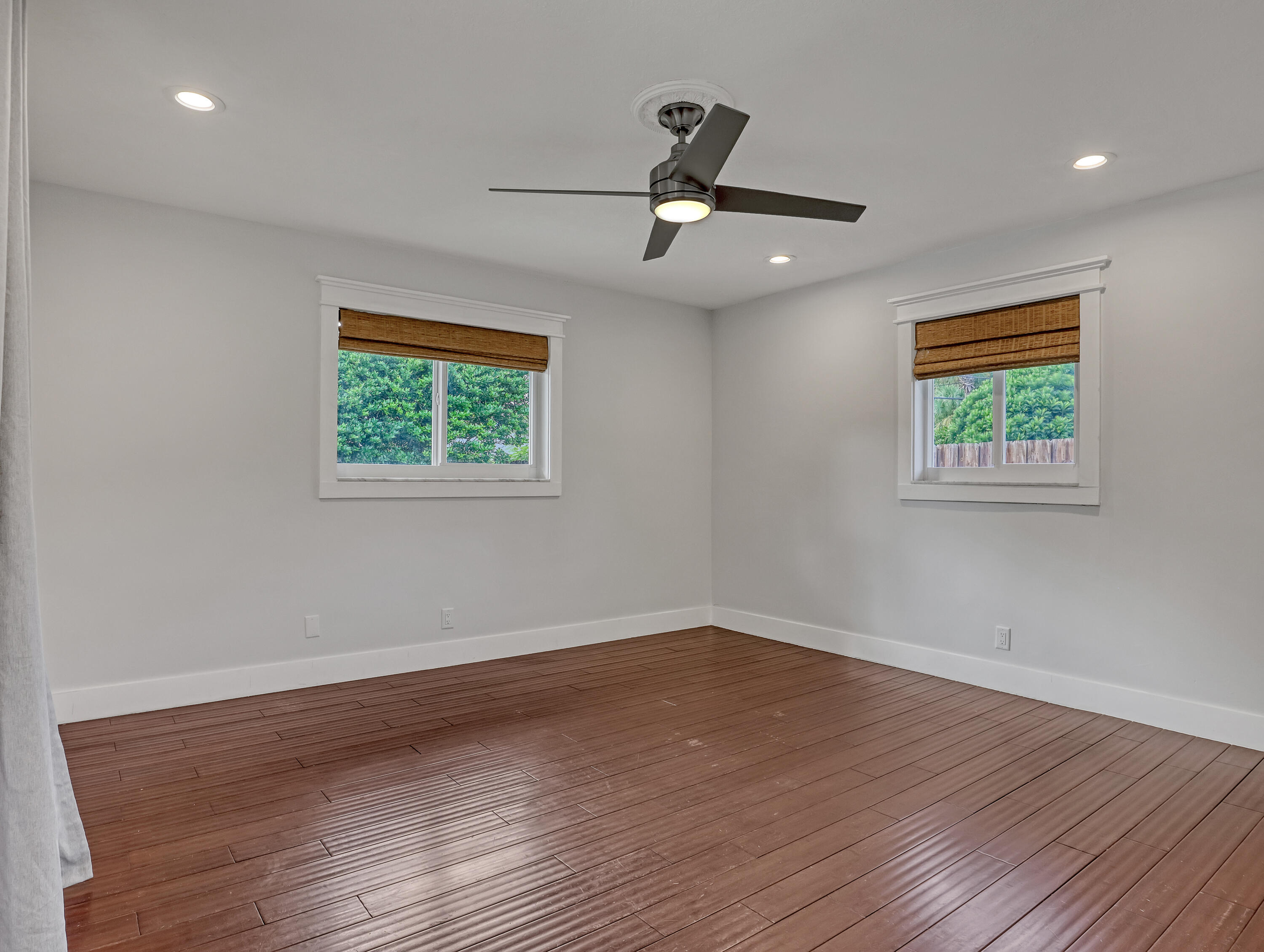 1298 Northwest 4th Street Boca Raton, FL 33486 - Photo 20 of 36 a view of an empty room with wooden floor and a window