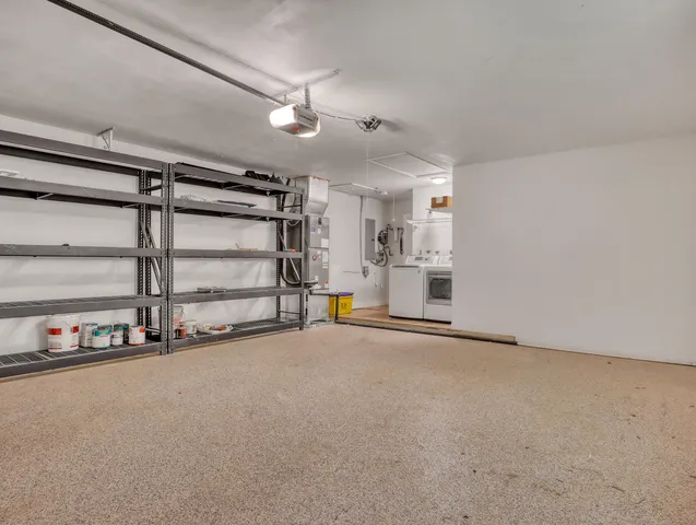 an empty room with gym equipment and windows
