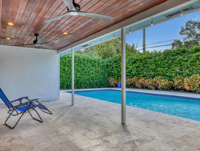 a view of a backyard with plants and a patio