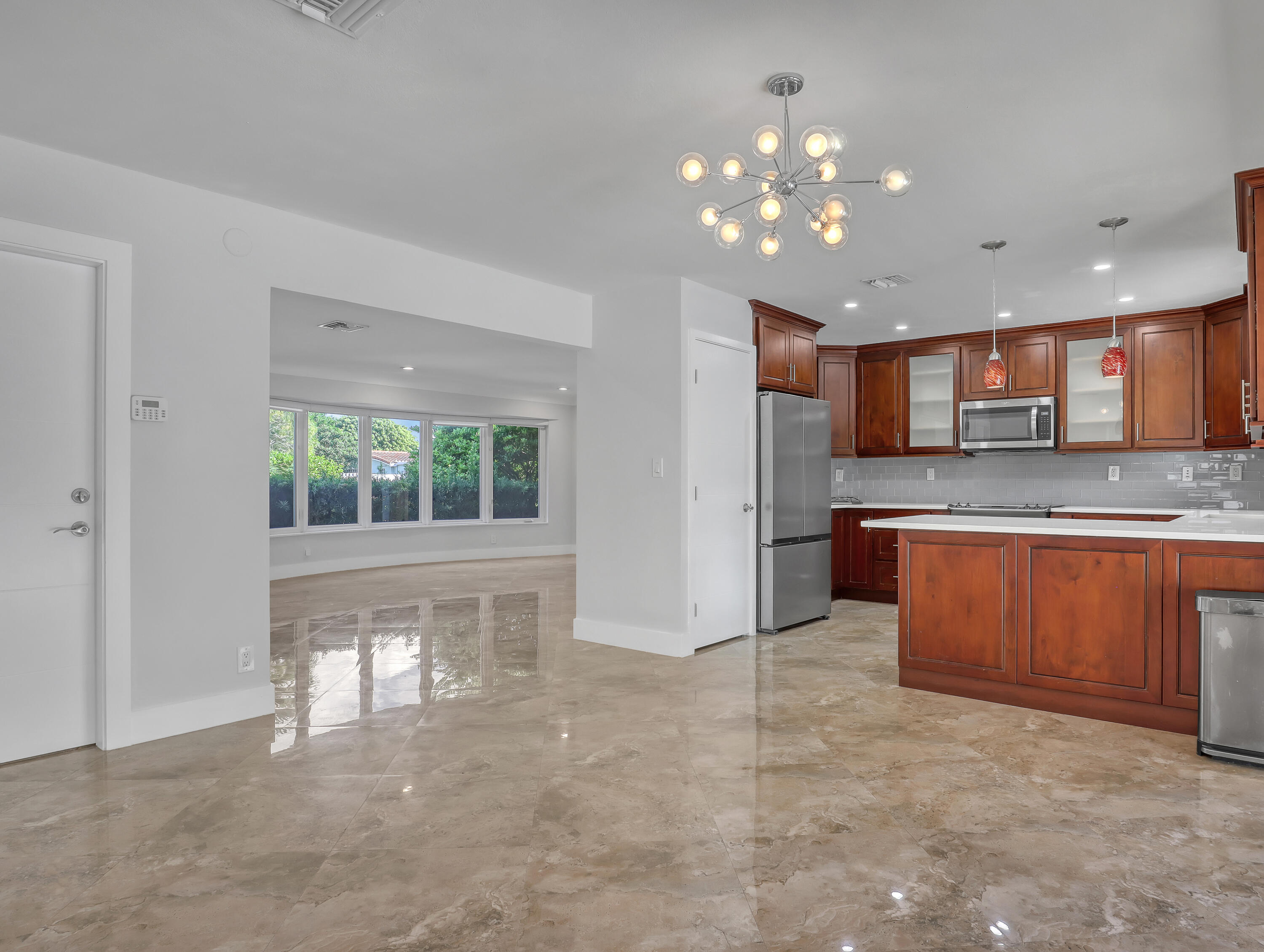 1298 Northwest 4th Street Boca Raton, FL 33486 - Photo 9 of 36 a view of kitchen with kitchen island granite countertop a stove top oven a sink and dishwasher