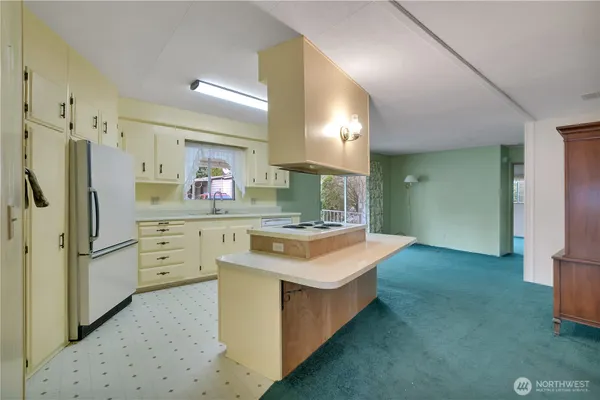 a kitchen with white cabinets and white appliances